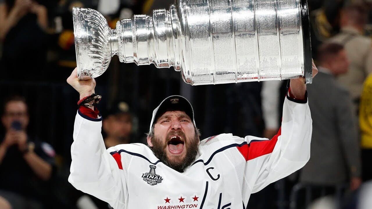 Alex Ovechkin celebrating with the Stanley Cup after leading the Washington Capitals to victory in the NHL Finals