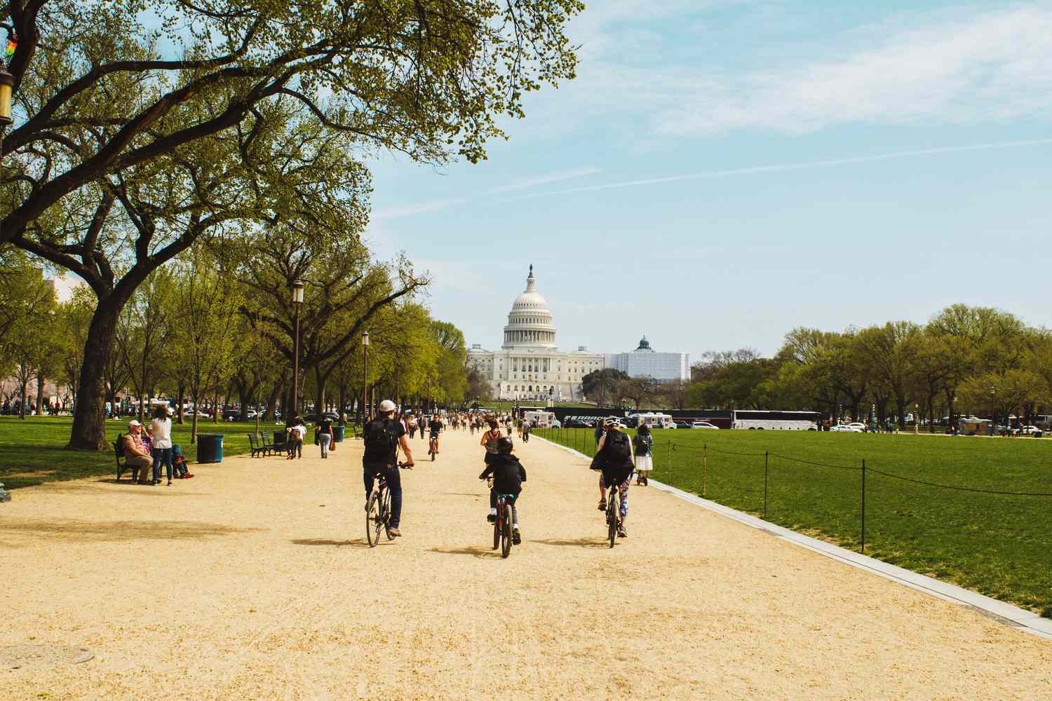 Tourists visiting the National Mall in Washington, D.C., with historic landmarks in the background
