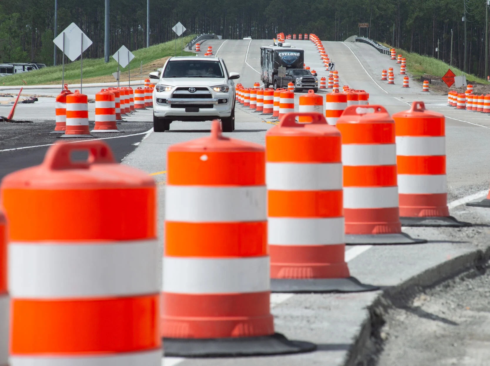 Traffic navigates through orange and white construction barrels, representing the extensive road improvements required on Courthouse Road and I-95 for the Stafford Buc-ee's project.
