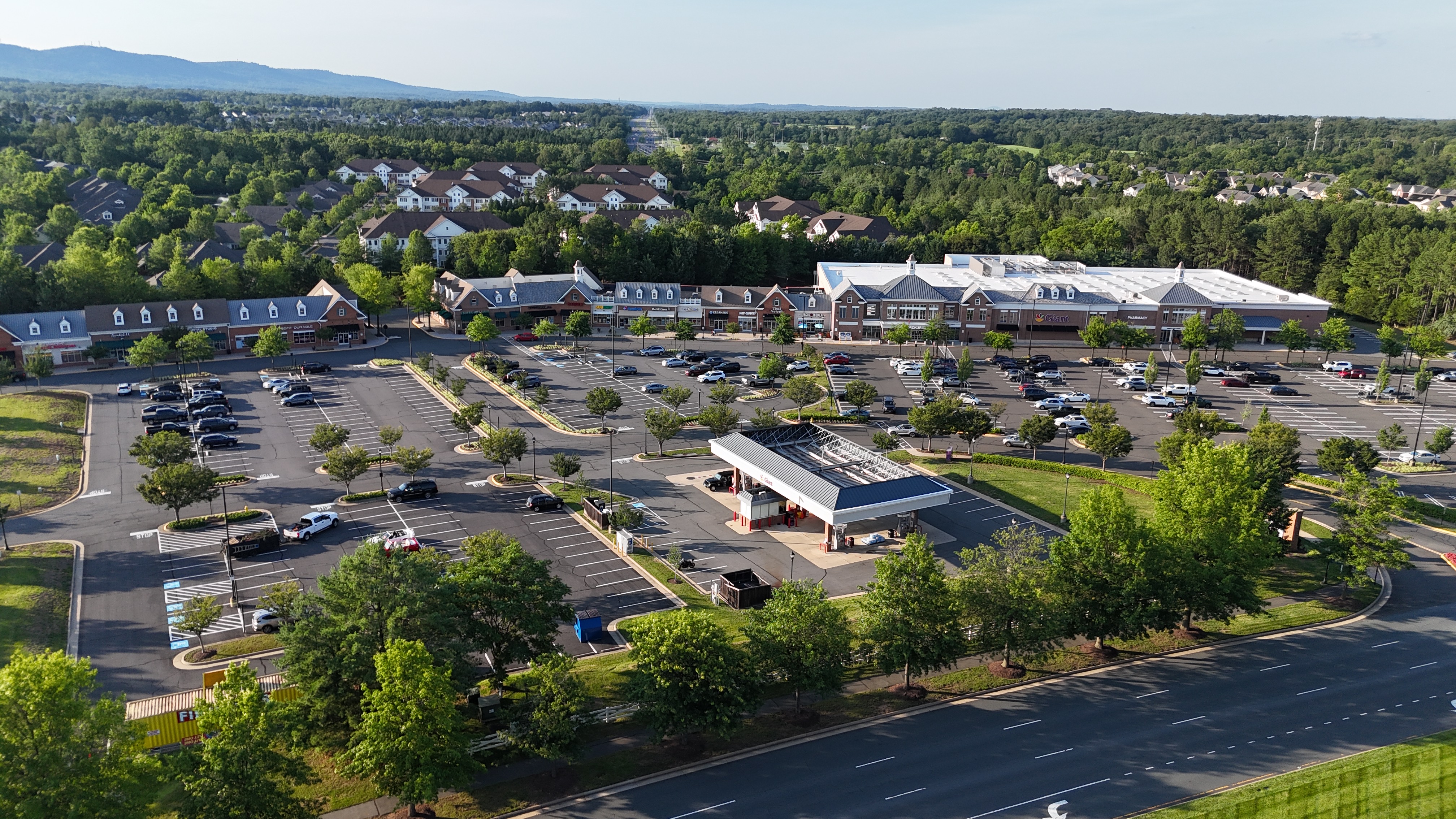 Aerial photograph of the Dominion Valley Shopping Center in Haymarket, VA, featuring a Giant grocery store and a gas station.