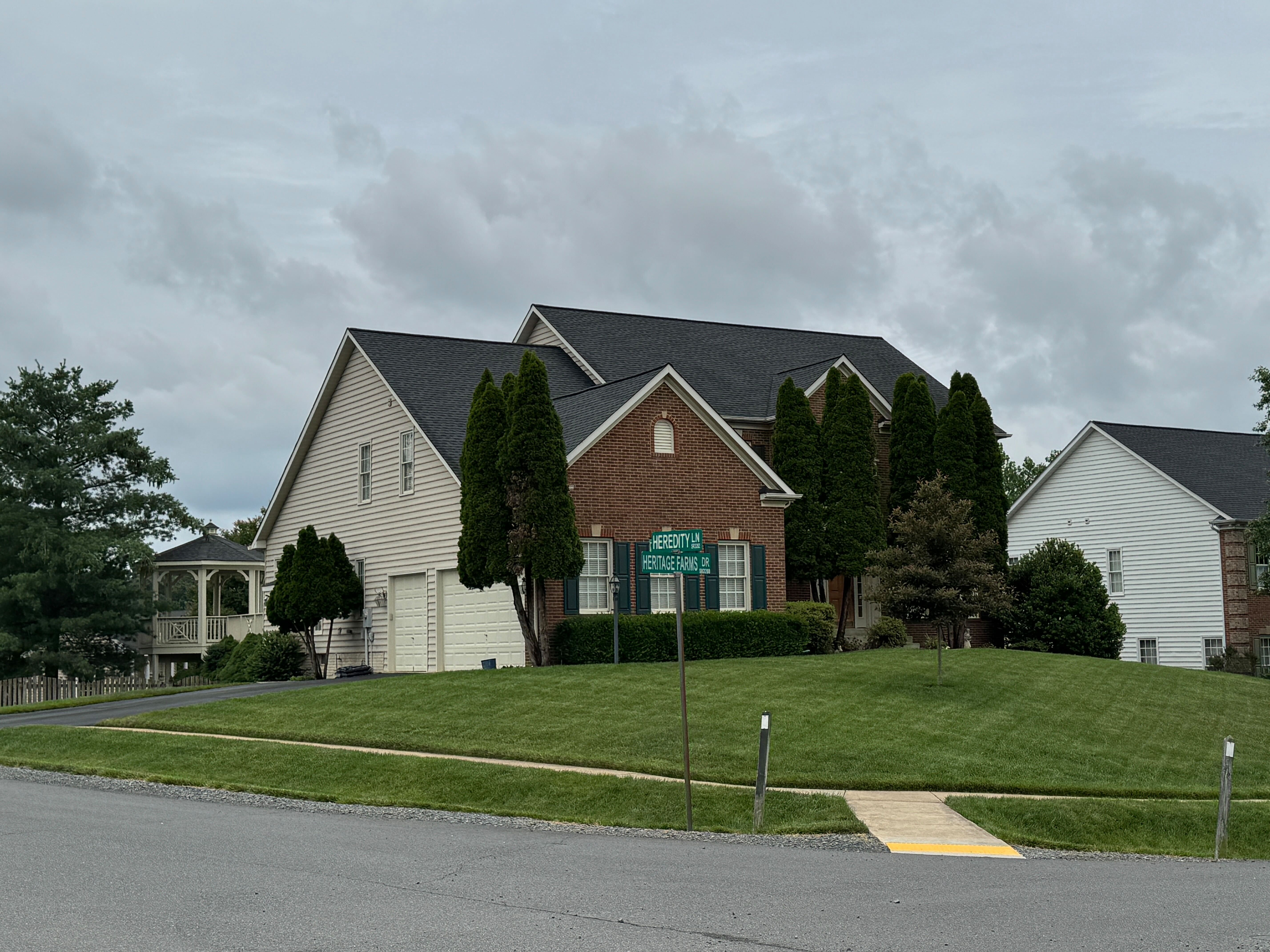 A two-story home with brick and siding on the corner of Herbert Lane and Westlake Terrace Drive in the Oak Valley neighborhood.