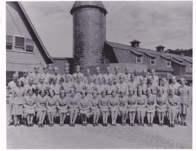 A historic, black and white photograph of the men and women of the Army Auxiliary Corps and other personnel stationed at Vint Hill during WWII, who served as secret codebreakers and analysts.