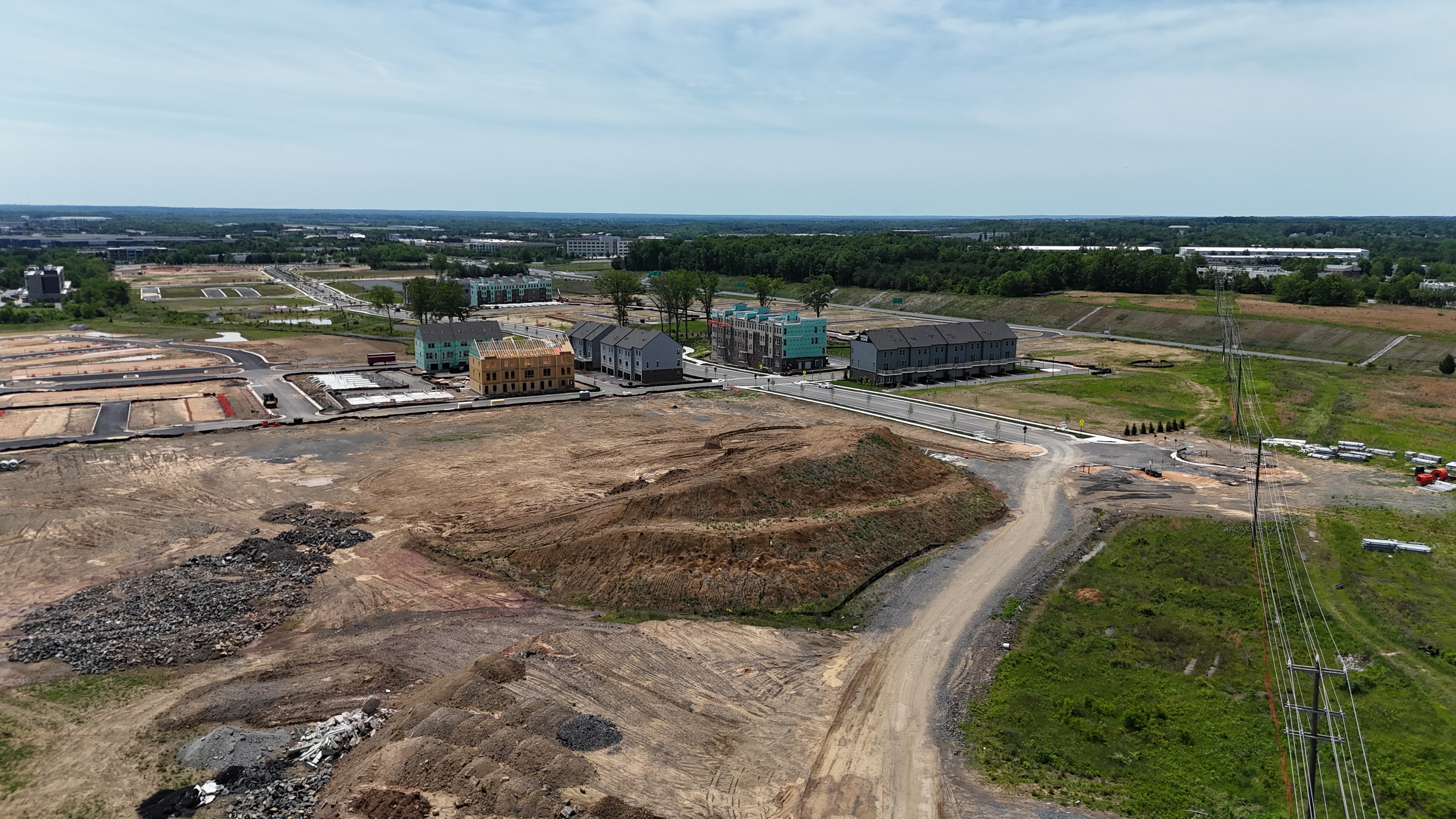 Aerial view of Stanley Martin townhomes under construction at Innovation Town Center in Northern Virginia, showing various stages of completion.